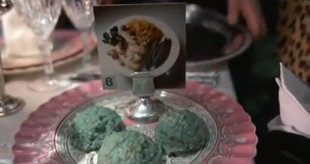 scene from brazil (1985) where the restaurant food is just colored slop with a picture of what it's supposed to taste like
